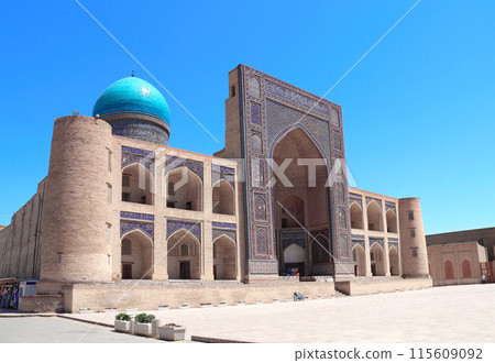 Facade of Mir i Arab madrassa, Bukhara, Uzbekistan. Madrasah Mir Arab, Poi-Kalyan (Poi Kalon) islamic religious complex in old town in Bukhara. Inscription above the entrance is a quote from the Koran 115609092