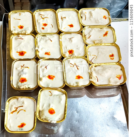 Sweet Rabdi or Rabri made with pure milk garnished with kesar. Served in a bowl over moody background at sweet shop 115609845