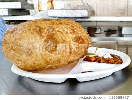 Chole bhature is a North Indian food dish. A combination of chana masala and bhatura or puri 115609857