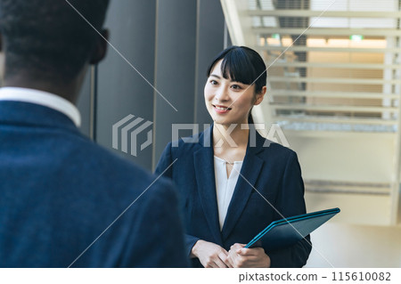 Group of multinational business people having a conversation in a lobby Group of multinational business people having a conversation in a lobby 115610082