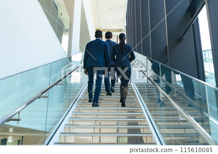A group of multinational business people walking up the stairs 115610085
