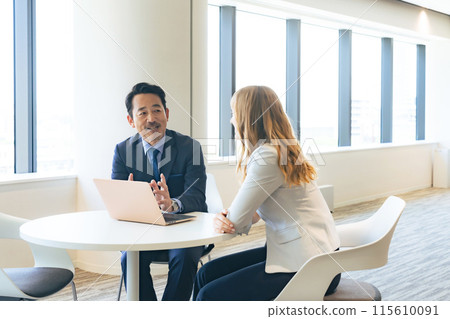 Group of multinational business people having a conversation in a lobby Group of multinational business people having a conversation in a lobby 115610091