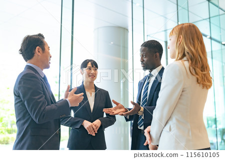 Group of multinational business people having a conversation in a lobby Group of multinational business people having a conversation in a lobby 115610105