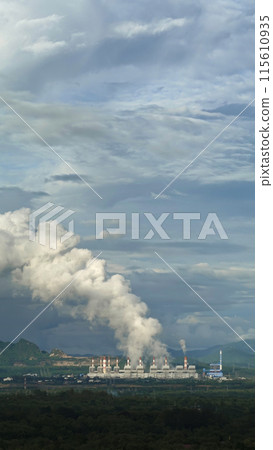 The pipe cooling tower emits an industrial white steam, creating a conceptual environment 115610935