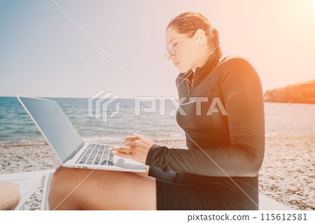 woman laptop sea. Working remotely on seashore. Happy successful lady, freelancer working on sea beach, relieves stress from work to restore life balance. Freelance, remote work on vacation 115612581