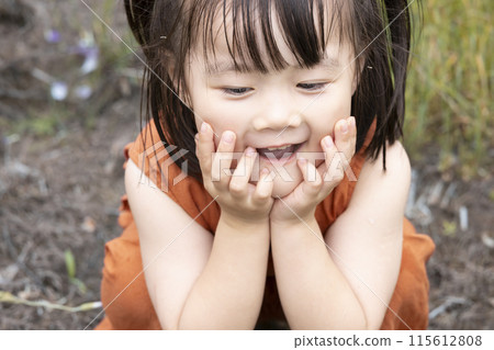 Cute girl walking in a flower field 115612808