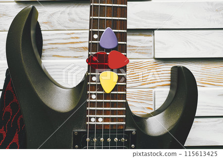 Fretboard of electric guitar with plectrums mediators Fretboard of electric guitar with plectrums mediators 115613425