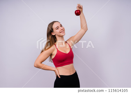Cropped of sporty female with well fit body holding apple, healthy food and fit body concept Cropped of sporty female with well fit body holding apple, healthy food and fit body concept 115614105