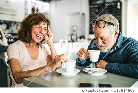 Happy senior couple sitting in coffeeshop, looking at each other. Romantic date for elderly couple in love. 115614602