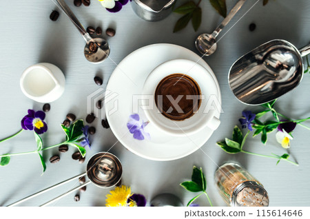 Cup with hot espresso and coffee bean and barista tools on white table. 115614646