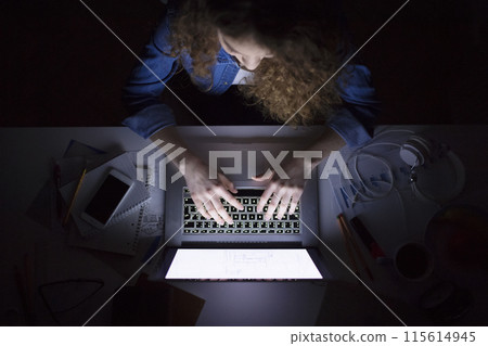 A beautiful university student having evening online class, e-learning sitting at home. Online consultation. A beautiful university student having evening online class, e-learning sitting at home. Online consultation. 115614945