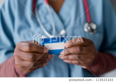Close-up of a medical worker presenting an insurance membership card Close-up of a medical worker presenting an insurance membership card 115615183