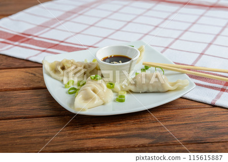 Dumplings are small, savory, or sweet-filled dough pockets, often boiled, steamed, or fried. 115615887