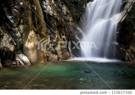 Deep emerald green pool and silk waterfall Deep emerald green pool and silk waterfall 115617100