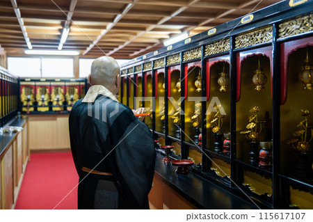 A monk praying in the memorial hall A monk praying in the memorial hall 115617107