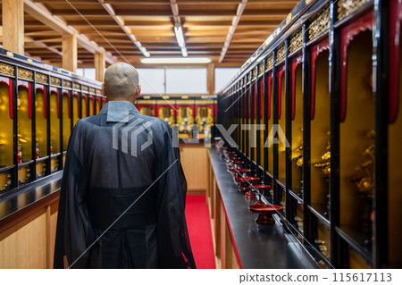 A monk praying in the memorial hall A monk praying in the memorial hall 115617113