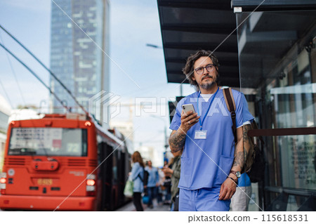 Doctor wating foth the bus at bus stop, going home from work. Work-life balance of healthcare worker. 115618531