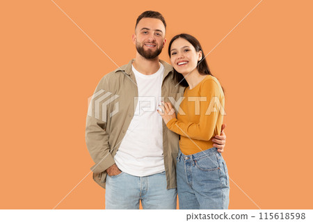 A man and a woman are standing side by side, facing forward. They appear to be looking in the same direction. Both individuals are casually dressed and have neutral expressions on their faces. A man and a woman are standing side by side, facing forward. They appear to be looking in the same direction. Both individuals are casually dressed and have neutral expressions on their faces. 115618598