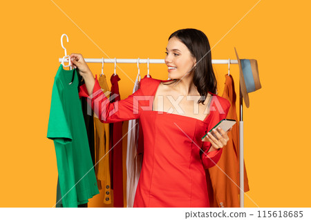 A woman is standing in front of a clothing rack, browsing through the different items. She appears focused and intent on finding something that catches her eye. A woman is standing in front of a clothing rack, browsing through the different items. She appears focused and intent on finding something that catches her eye. 115618685