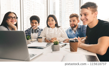 Tutorial video. Students using laptop in university library, looking at screen together, panorama Tutorial video. Students using laptop in university library, looking at screen together, panorama 115618737