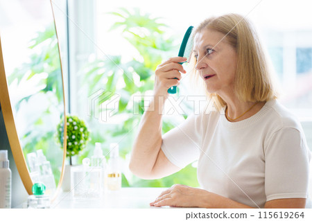 Skin care for senior woman. Anti-aging cream. 115619264