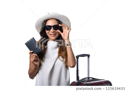 Smiling woman traveler holding passport standing with suitcase on white background. Vacation and travel concept 115619433