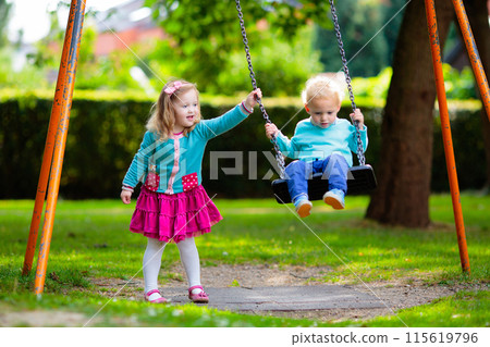 Kids explore nature. Children play in sunny park. 115619796
