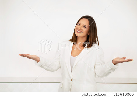 Business Offer And Consultation. Happy Businesswoman Smiling Looking At Camera, Standing Over White Office Wall Indoor, Gesturing And Consulting, Inviting To Use Her Agent Or Advisor Services Business Offer And Consultation. Happy Businesswoman Smiling Looking At Camera, Standing Over White Office Wall Indoor, Gesturing And Consulting, Inviting To Use Her Agent Or Advisor Services 115619809