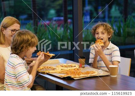 Family eating pizza. Italian restaurant. Family eating pizza. Italian restaurant. 115619923