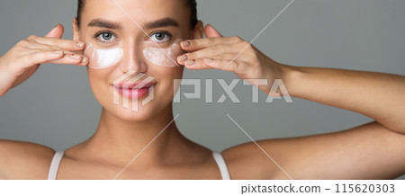 Woman with Collagen Pads under her Eyes on Grey Background, Panorama Woman with Collagen Pads under her Eyes on Grey Background, Panorama 115620303