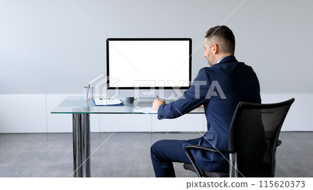 Businessman in formal suit sitting at table in front of computer with blank screen, mockup for business website design. Employee man offering free space for your online advertisement Businessman in formal suit sitting at table in front of computer with blank screen, mockup for business website design. Employee man offering free space for your online advertisement 115620373