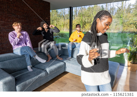 A group of friends is joyfully socializing and bonding together in a contemporary living space 115621381