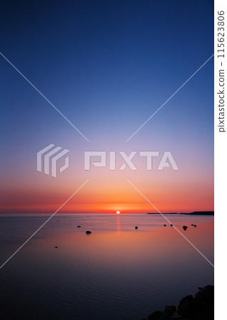 Watching the sun rise over the calm sea in early spring from the northernmost point of Japan 115623806