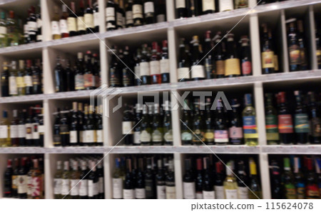 Concept blurred image. Alcohol showcase blurred background. Blurred abstract background of shelf in supermarket Concept blurred image. Alcohol showcase blurred background. Blurred abstract background of shelf in supermarket 115624078