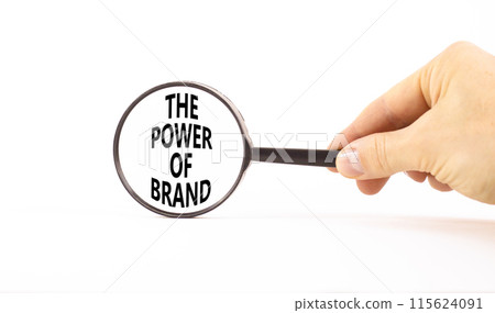 The power of brand symbol. Concept words The power of brand on beautiful magnifying glass. Beautiful white table white background. Businessman hand. Business the power of brand concept. Copy space. 115624091