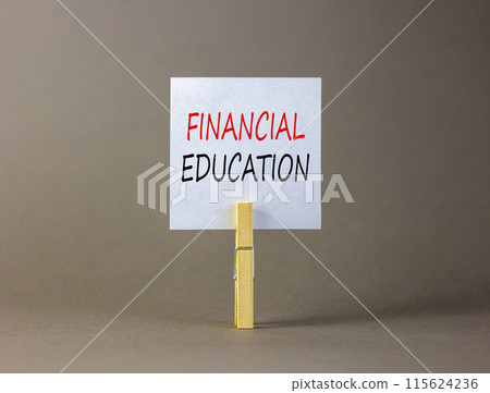 Financial education symbol. Concept words Financial education on beautiful white paper on wooden clothespin. Beautiful grey background. Business Financial education concept. Copy space. 115624236