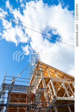 New construction site, wooden two-story house under construction New construction site, wooden two-story house under construction 115624343