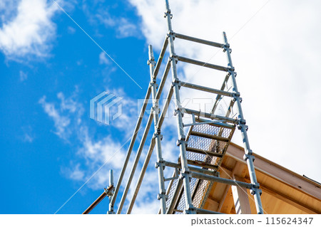 New construction site, wooden two-story house under construction 115624347