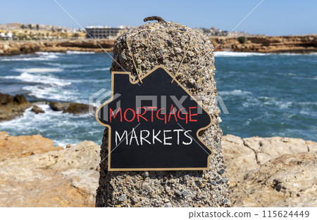 Mortgage markets symbol. Concept words Mortgage markets on beautiful black chalk blackboard. Beautiful stone beach blue sea sky background. Business mortgage markets concept. Copy space. Mortgage markets symbol. Concept words Mortgage markets on beautiful black chalk blackboard. Beautiful stone beach blue sea sky background. Business mortgage markets concept. Copy space. 115624449