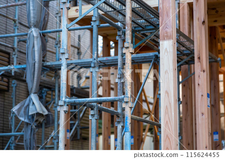 New construction site, wooden two-story house under construction New construction site, wooden two-story house under construction 115624455