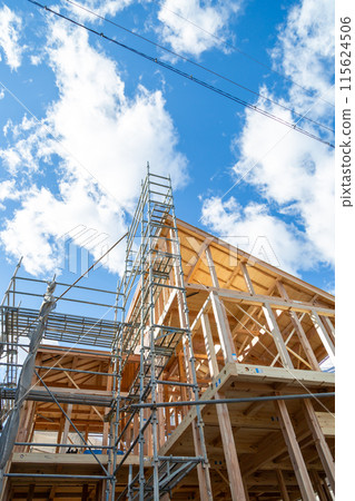 New construction site, wooden two-story house under construction New construction site, wooden two-story house under construction 115624506