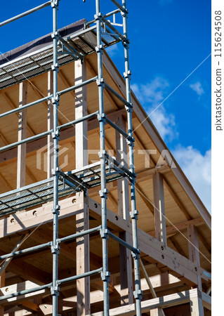 New construction site, wooden two-story house under construction 115624508