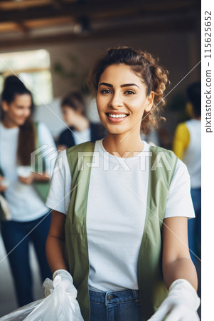 Smiling Woman in Green Vest Holding a Bag Smiling Woman in Green Vest Holding a Bag 115625652