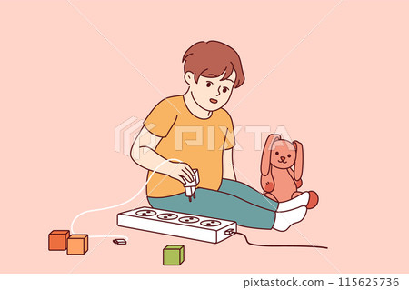 Little boy plays with electrical appliances at risk of getting electric shock and injury 115625736