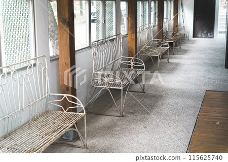 An aisle lined with old benches An aisle lined with old benches 115625740