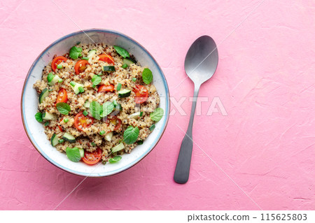 Quinoa tabbouleh salad in a bowl, a healthy dinner with tomatoes and mint Quinoa tabbouleh salad in a bowl, a healthy dinner with tomatoes and mint 115625803