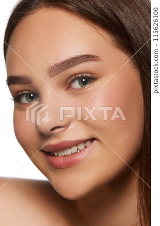 Portrait of beautiful young girl with smooth, perfect face, with nude makeup, blushing cheeks look isolated on white background Portrait of beautiful young girl with smooth, perfect face, with nude makeup, blushing cheeks look isolated on white background 115626100