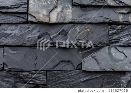 Close-up detailed texture of natural slate stone wall, with dark gray monochrome pattern, stacked and durable, perfect for exterior and interior architecture and construction design backgrounds 115627016