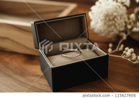 Single wedding ring in a luxurious velvet box, symbolizing commitment and love 115627608