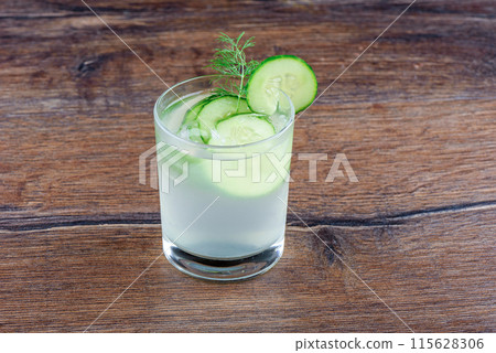 Cucumber refreshing drink glass with cucumber circles and decorated with dill. Cucumber refreshing drink glass with cucumber circles and decorated with dill. 115628306